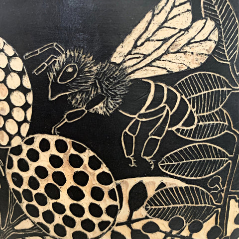 Detail of bee from black and white terra sigillata and sgraffito jar with lid edged in pine needles by Carolyn Blazeck at Cottage Curator - Sperryville VA Art Gallery