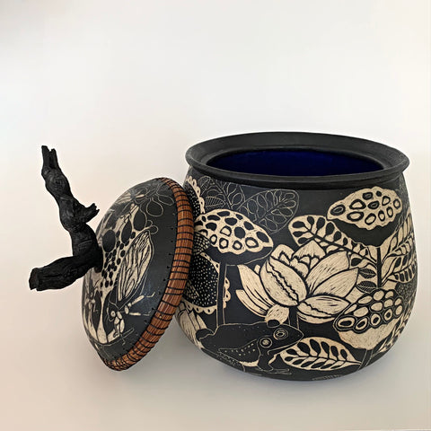 Lidded ceramic vessel with grape vine handle in black and white terra sigliatta technique with plants, insects, and frog by Carolyn Blazeck at Cottage Curator - Sperryville VA Art Gallery