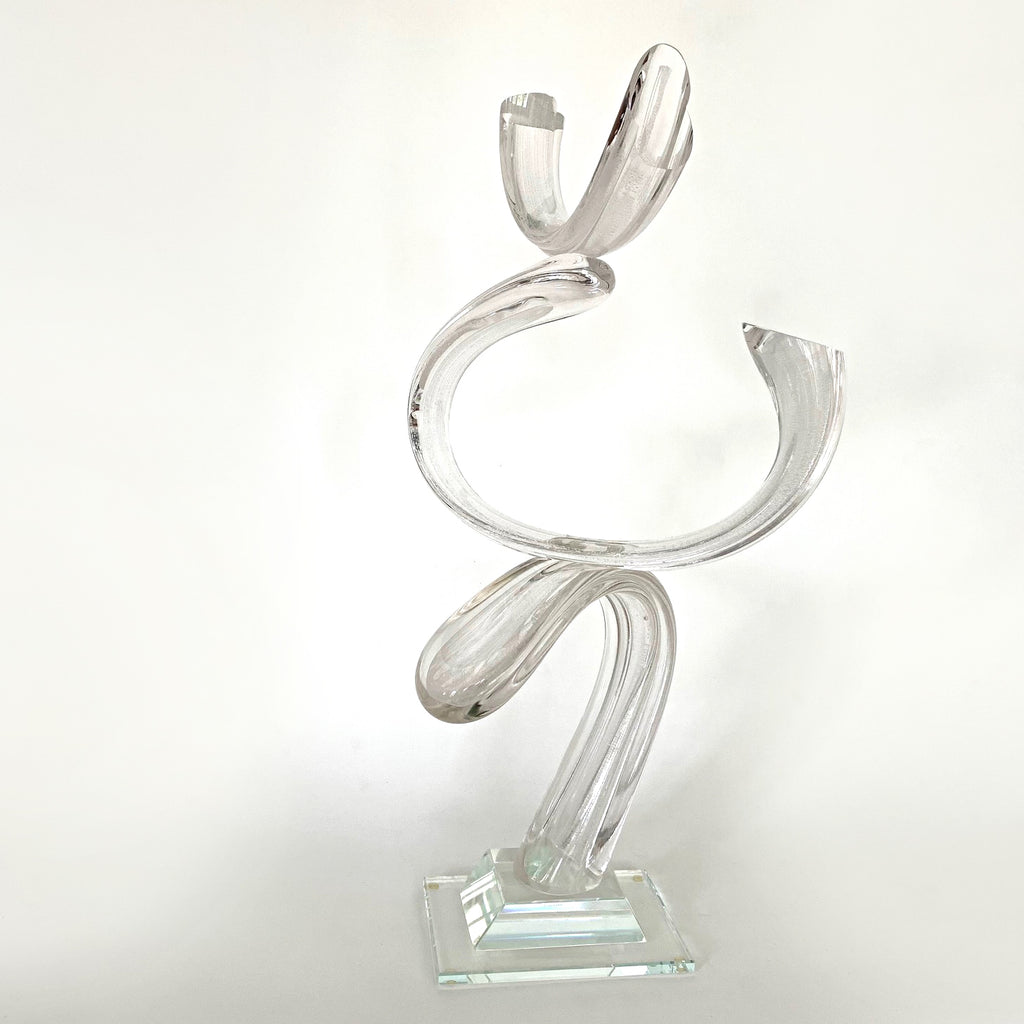 Clear blown-glass sculpture featuring three curves balanced on a square base by Neil Duman at Cottage Curator - Sperryville VA Art Gallery