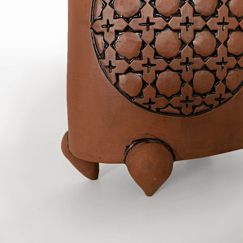Detail of stoneware vessel in natural tan clay color with carved patterned circles and three feet by Yoshi Fujii at Cottage Curator - Sperryville VA Art Gallery