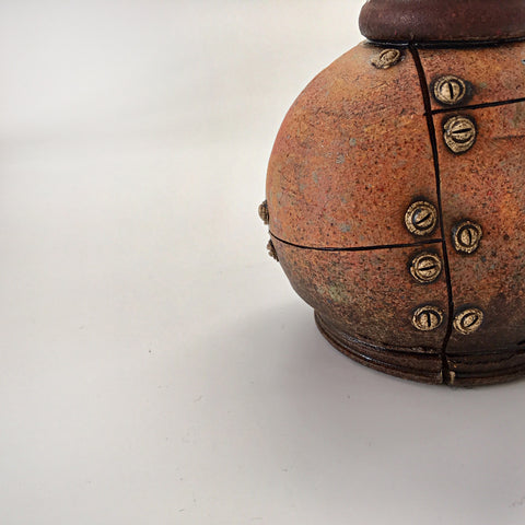 Detail view of industrial ceramic vessel with rivets by Steve Palmer