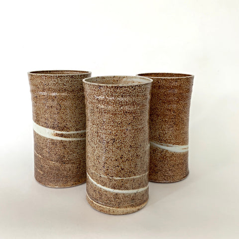 Set of three cylindrical vases in brown textured finish with white swirls by Virginia Rood Pates at Cottage Curator - Sperryville VA Art Gallery